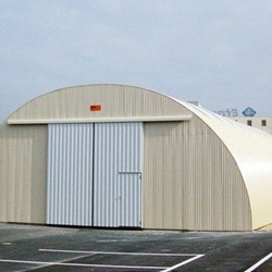 small shed with closed gate, painted in white color (ral 9003) for maximum solar heat reflection