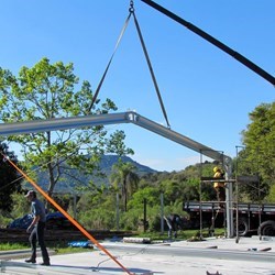 a truck crane lifts the first span and puts it in place