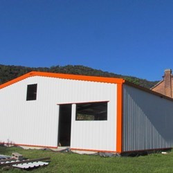 outside view of sheeting, white trapezoidal sheeting, galvanized and pre-painted, finishing in orange adds a nice accent